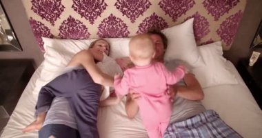 Family Playing Together on Bed at Home