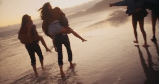 Ystävät ottaa hauska reppuselässä ratsastaa rannalla — kuvapankkivideo