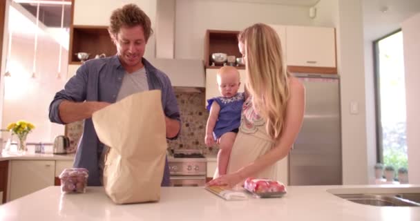 Family with Infant Daughter Unpacking Groceries — Stock Video