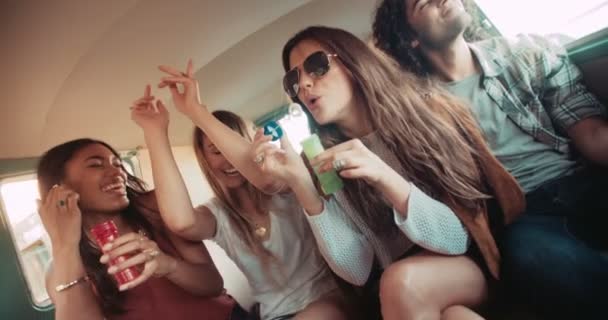 Friends having bubbles party inside a vintage van — Stock Video