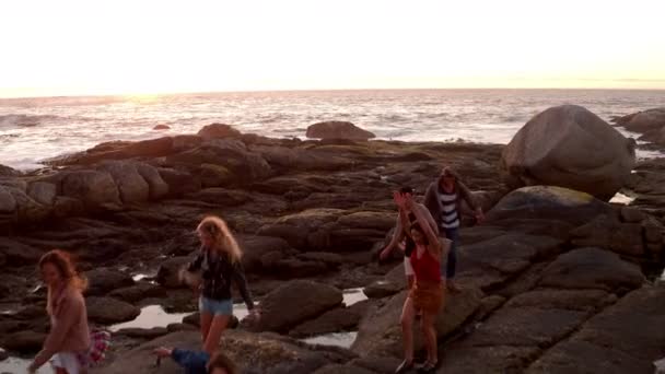 Friends dancing and partying at sunset at beach — Stock Video