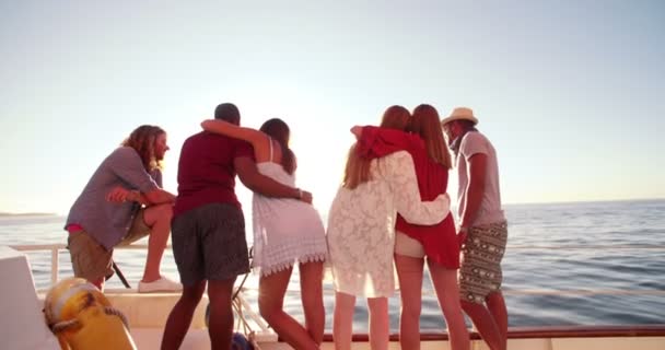 Grupo de amigos olhando para o horizonte a partir de um iate — Vídeo de Stock