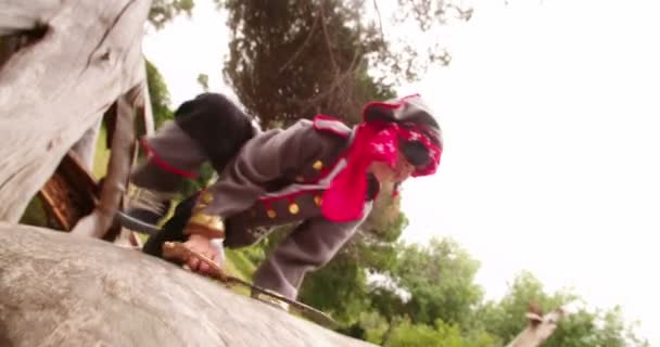 Boy dressed up as pirate on fallen tree — Stock Video