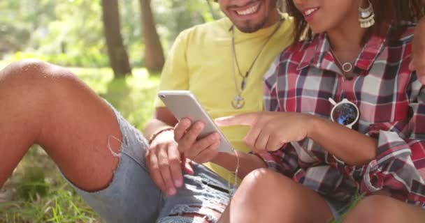 Couple Texting on Smartphone Together in park — Stock Video