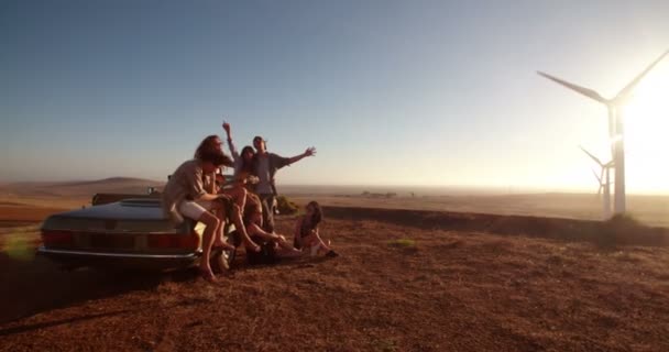 Friends playing guitar on vintage convertible car — Stock Video