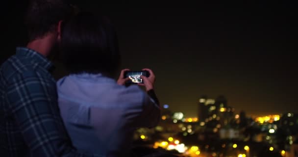 Couple taking a picture of the skyline with a smartphone — Stock Video