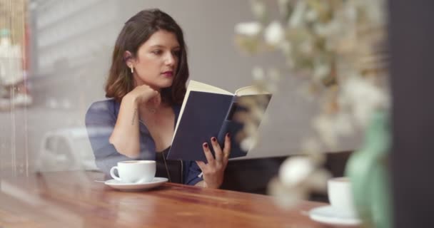 Chica bebiendo café y leyendo libro en Café — Vídeo de stock