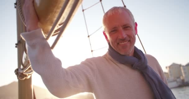Mature man on yacht in picturesque sunset — Stock Video