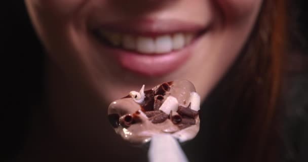 Young woman mouth eating chocolate ice cream — Stock Video