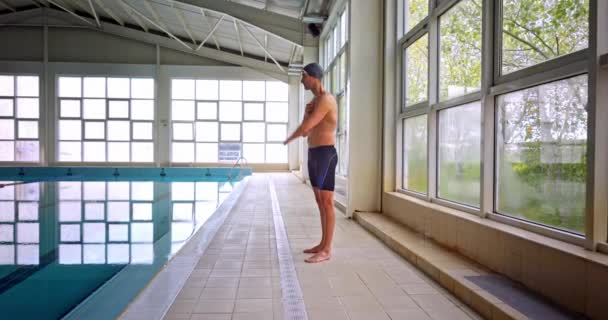 Amputált úszó nyújtókar úszás előtt fedett medencében — Stock videók