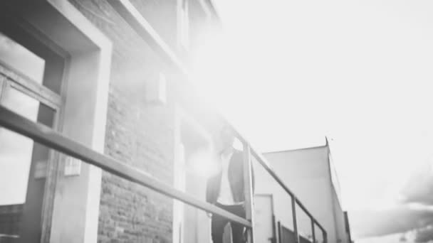 Young man walking in urban area and stops to enjoy the view — Stock Video