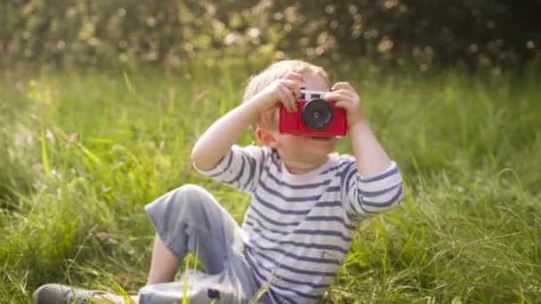 Little boy enjoys taking photos with toy camera — Stock Video