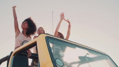 Afro kız ve arkadaşları kumsalda dans