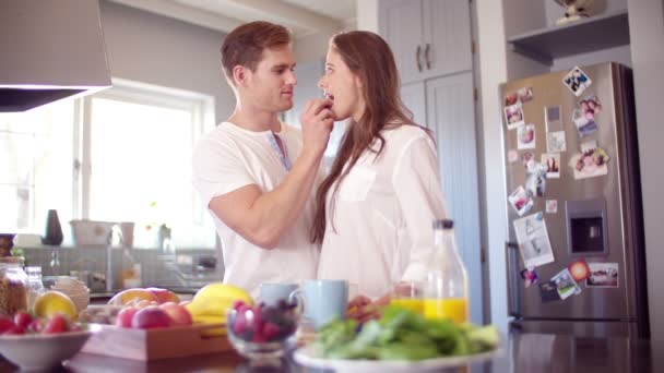 Boyfriend feeding his girlfriend a berry — Stock Video