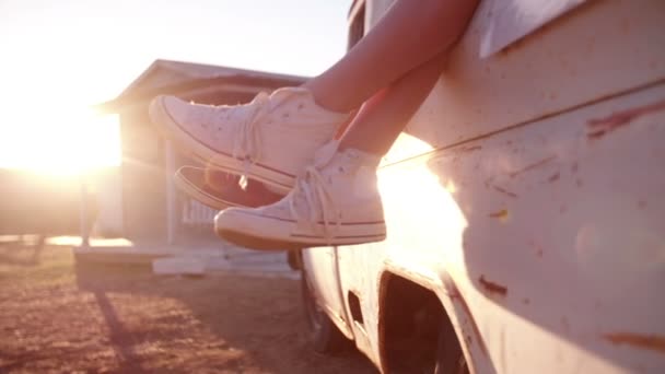 Adolescente parejas piernas colgando fuera de vehículo — Vídeo de stock