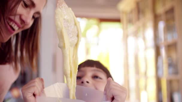 Girl and mom putting dough into tray — Stock Video