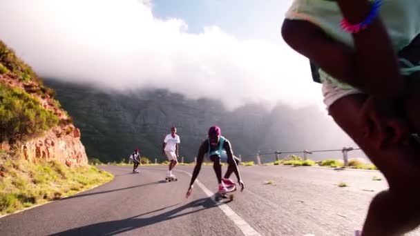 Skater girl downhill racing with friends — Stock Video