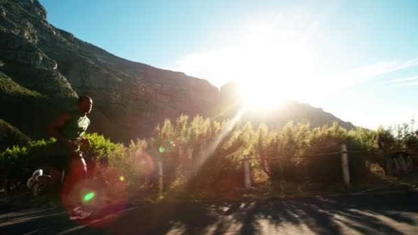 Runner sprinting on mountain road — Stock Video