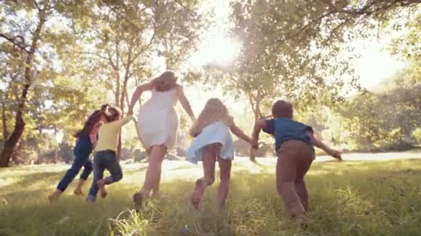 Woman running with kids through park