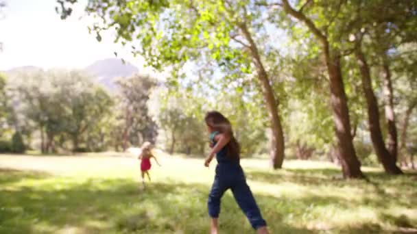 Little girls running through a field