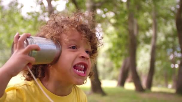 Boy with tin can phone — Stock Video