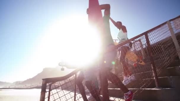 Teenagers wearing sneakers walking down steps — Stock Video