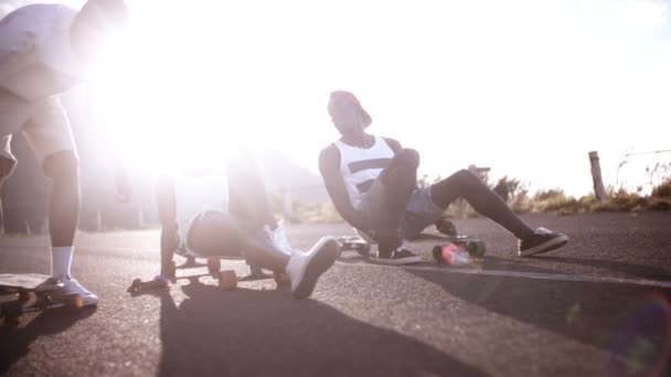 Girl with friends sitting on longboards — Stock Video