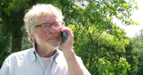 Oude man spreken op telefoon — Stockvideo