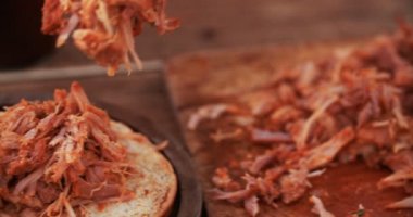 Lezzetli bir burger topuzun a konulmakta olan domuz eti çekti