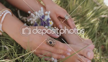 Çim taze çiçekler ile kızın ayak