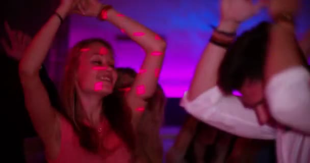 Young woman having fun dancing at party in club — Stock Video