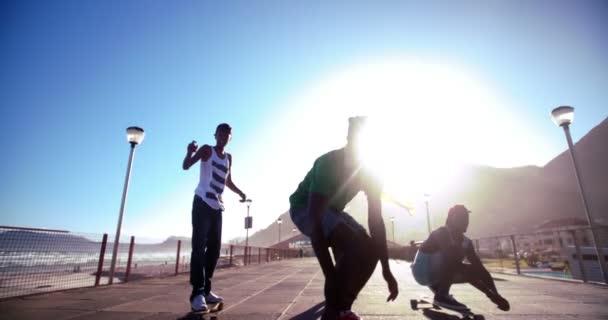 Skateboarders flying an American flag while skating — Stock Video