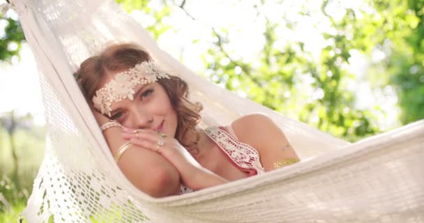 Smiling girl in hippie headband in a hammock — Stock Video