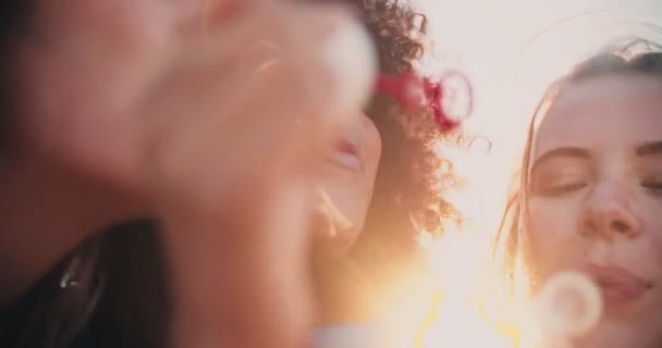 Afro girl and friends blowing bubbles — Stock Video