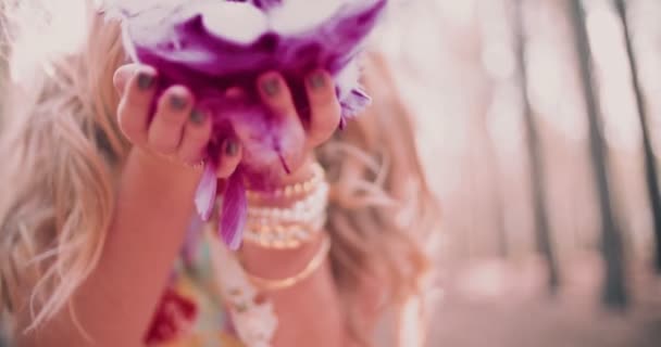 Boho girl blowing brightly coloured pink feathers — Stock Video