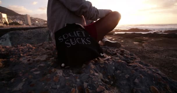 African American girl sitting on rock — Stock Video