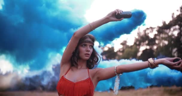 Girl with blue smoke flares in a park — Stock Video