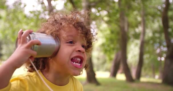 Boy with tin can phone — Stock Video