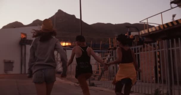Teen grunge girls running in an industrial setting — Stock Video