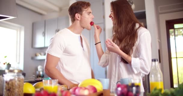 Woman feeding her boyfriend a strawberry — Stock Video