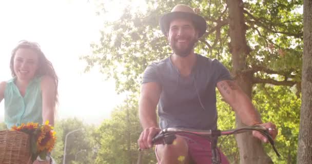 Young couple cycling happily together — Stock Video