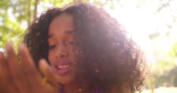 Afro girl blowing gold glitter — Stock Video