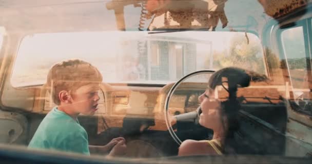 Children petending to drive an old vehicle — Stock Video