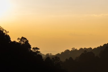 Arka plan olarak şafak anda dağlar silüeti