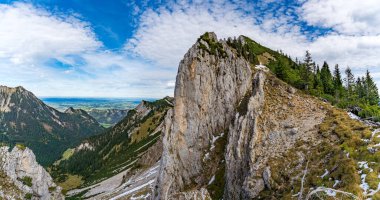 Nefes kesen bir panoramik manzara, Tannheimer Vadisi 'nin engebeli güzelliğini yakalar. Sonbahar ihtişamı, Fuessener Joechle' den Grosse Schlicke patikasına kadar sükunet ve macera uyandırır.