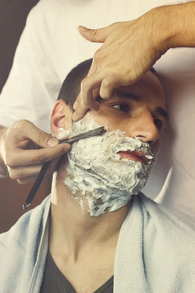 Young man at the barber — Stock Photo, Image