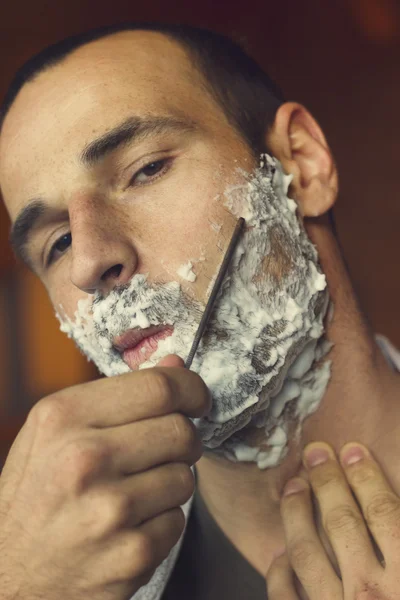 Young man shaving — Stock Photo, Image