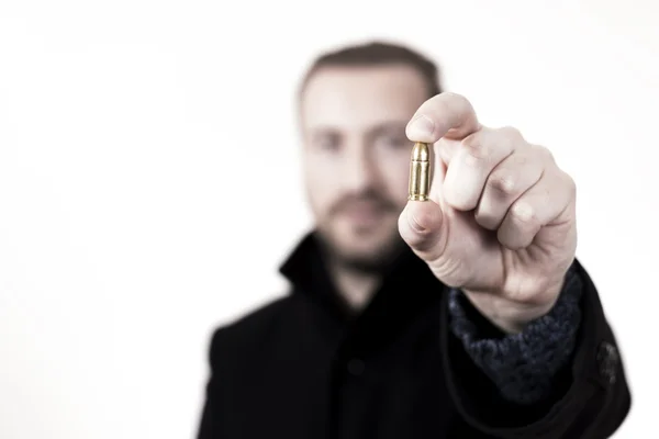 Gunmen with a bullet in his hand. — Stock Photo, Image