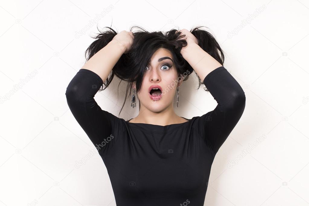 Surprised woman holding her hair.