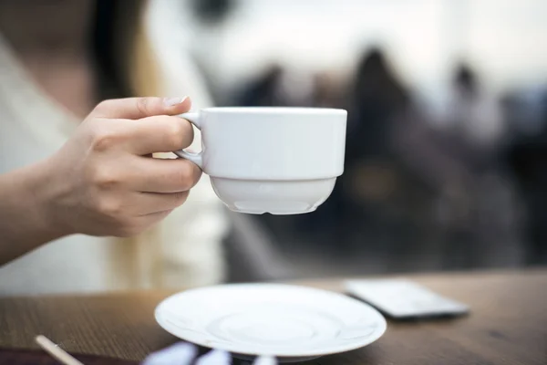 Woman holding a white coffee cup. — Stock Photo, Image